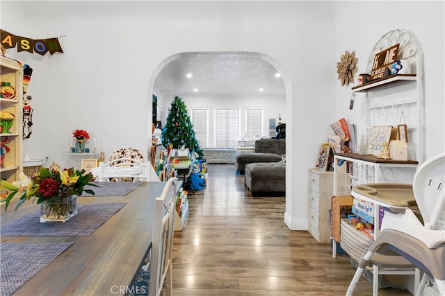 dining area with a textured ceiling and dark hardwood / wood-style flooring