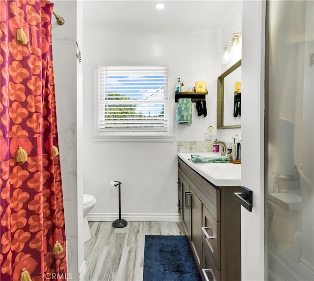 bathroom with vanity, hardwood / wood-style floors, toilet, and walk in shower