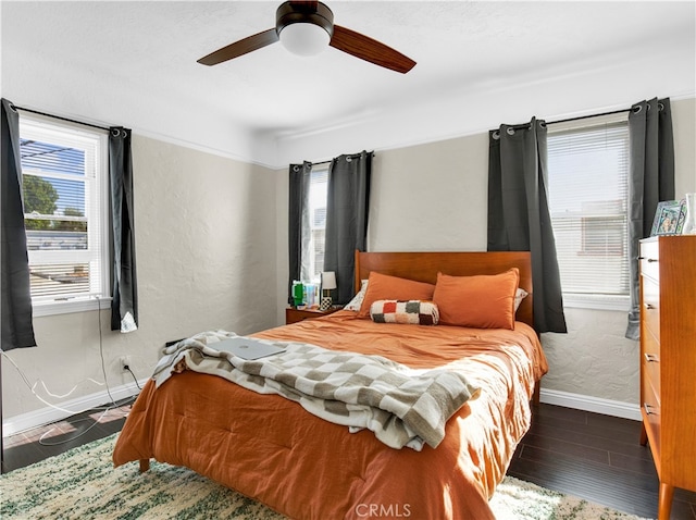 bedroom with ceiling fan and dark hardwood / wood-style floors