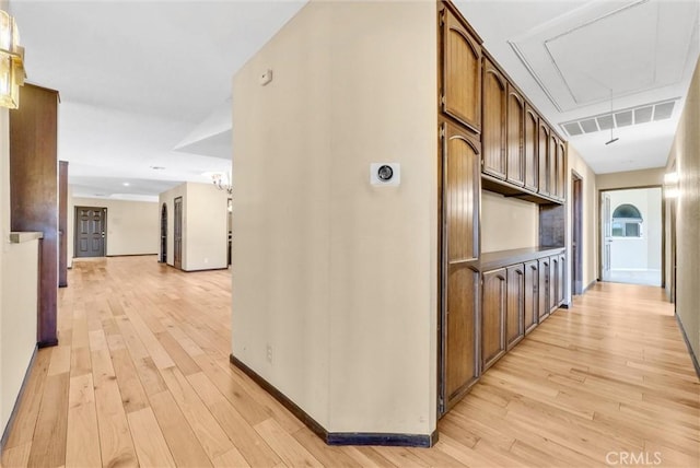 hallway with light hardwood / wood-style floors