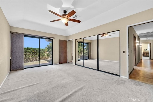 empty room with ceiling fan and light colored carpet