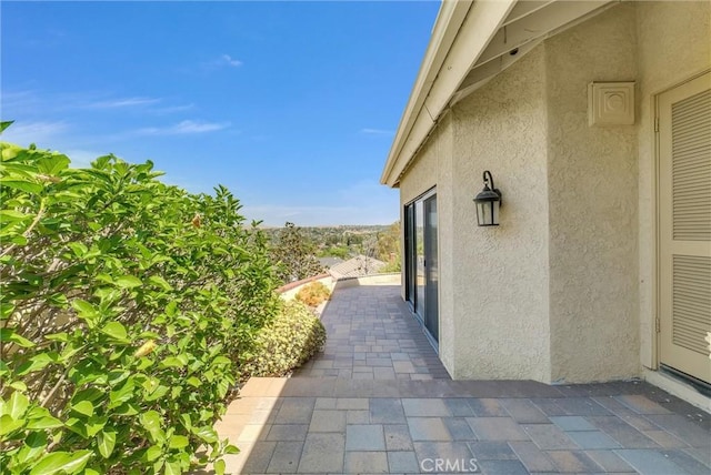 view of property exterior with a patio area