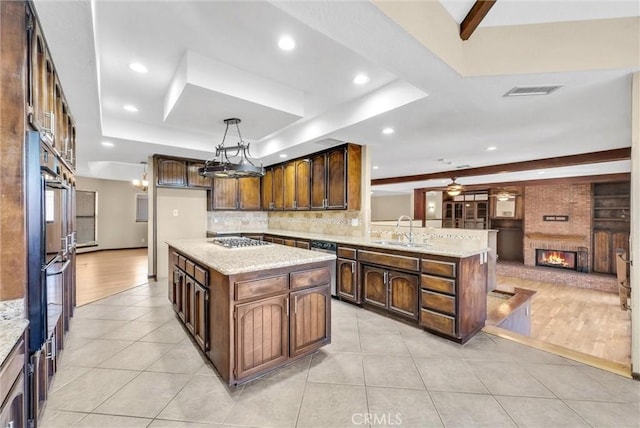 kitchen featuring tasteful backsplash, a kitchen island, and light wood-type flooring