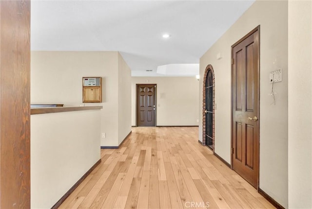 corridor with light hardwood / wood-style flooring