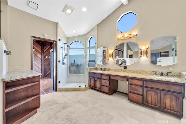 bathroom featuring vanity, high vaulted ceiling, and an enclosed shower