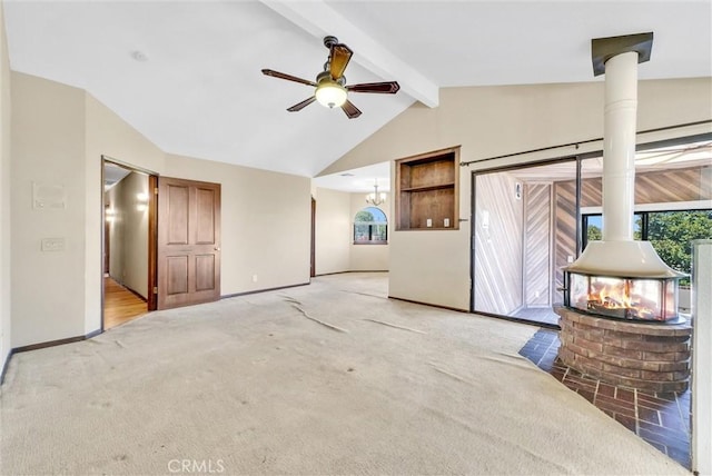 unfurnished living room featuring ceiling fan with notable chandelier, vaulted ceiling with beams, light colored carpet, and a wood stove