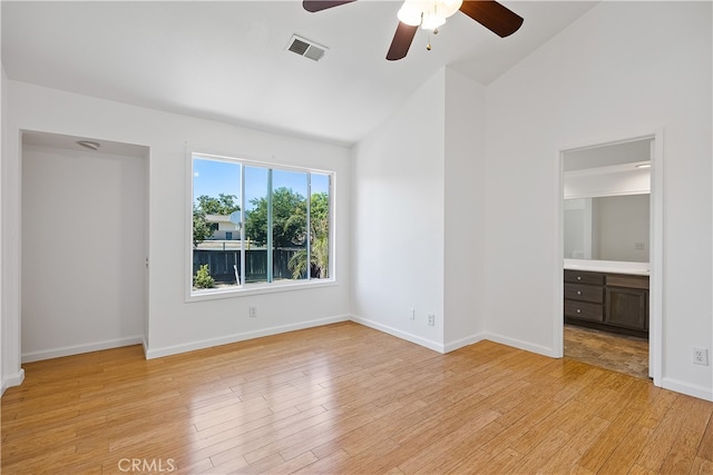 unfurnished bedroom featuring light hardwood / wood-style floors, ensuite bath, ceiling fan, and high vaulted ceiling