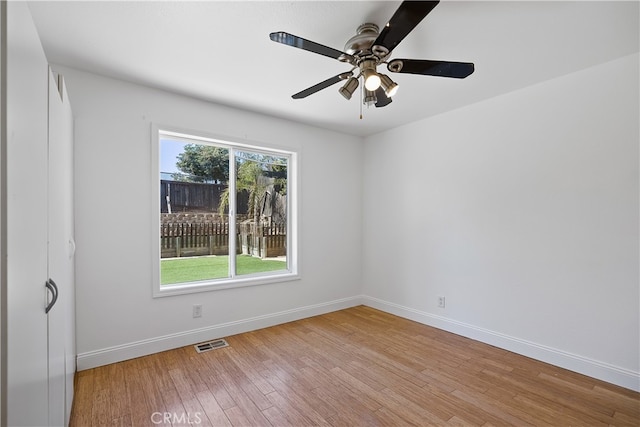 spare room with light wood-type flooring and ceiling fan