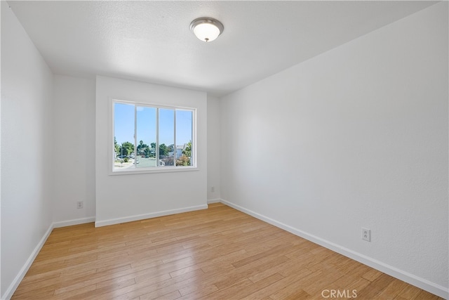 unfurnished room with light wood-type flooring