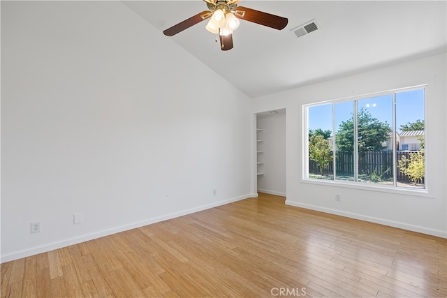 spare room featuring light hardwood / wood-style flooring, ceiling fan, and high vaulted ceiling