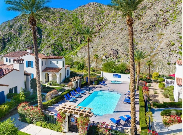 view of pool featuring a patio and a mountain view