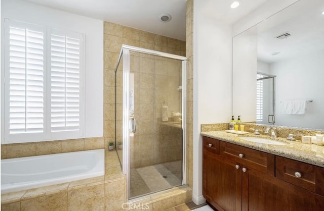 bathroom featuring vanity and plus walk in shower