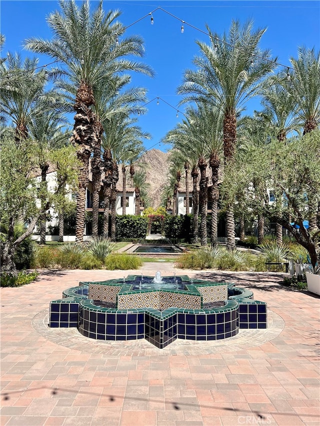 view of pool with a mountain view and a patio area