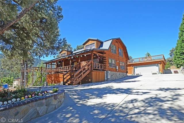 log home featuring a wooden deck