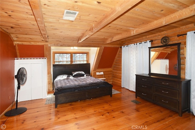 bedroom with vaulted ceiling with beams, wooden ceiling, and light wood-type flooring