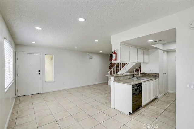 kitchen with dishwasher, white cabinets, a textured ceiling, and sink