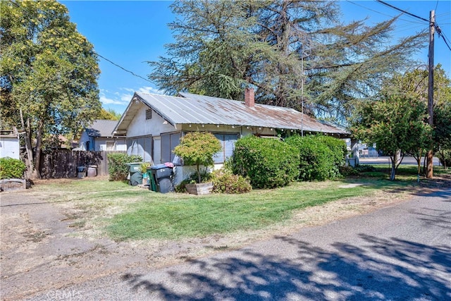 view of property exterior with a yard