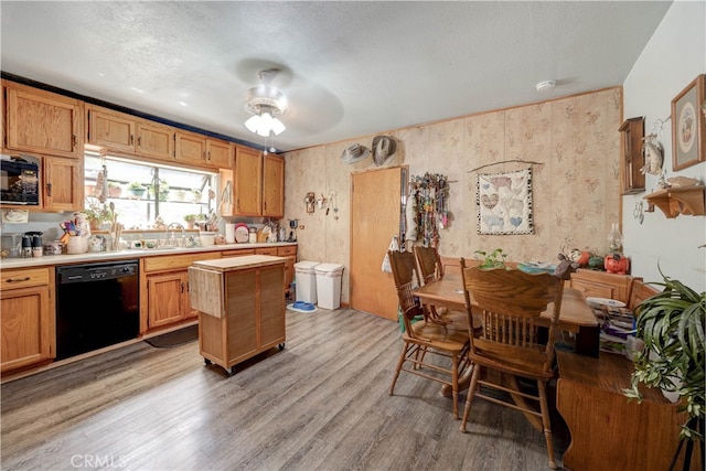 kitchen with ceiling fan, a textured ceiling, light hardwood / wood-style floors, and black appliances