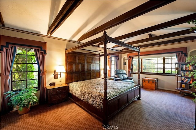 bedroom featuring carpet flooring, lofted ceiling with beams, and multiple windows