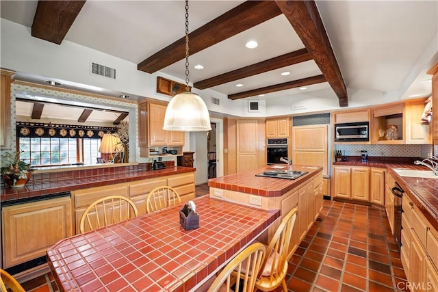 kitchen with a center island, decorative light fixtures, built in appliances, tile countertops, and beam ceiling