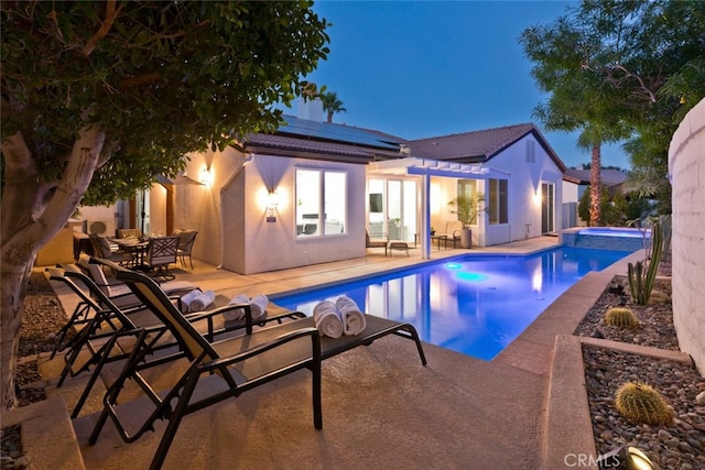 view of swimming pool featuring a patio, a pergola, and a pool with connected hot tub