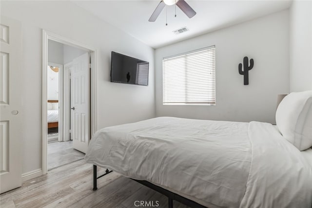 bedroom with ceiling fan, visible vents, baseboards, and wood finished floors