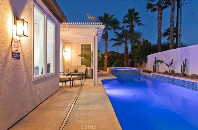 view of pool featuring a patio area, a pool with connected hot tub, and fence