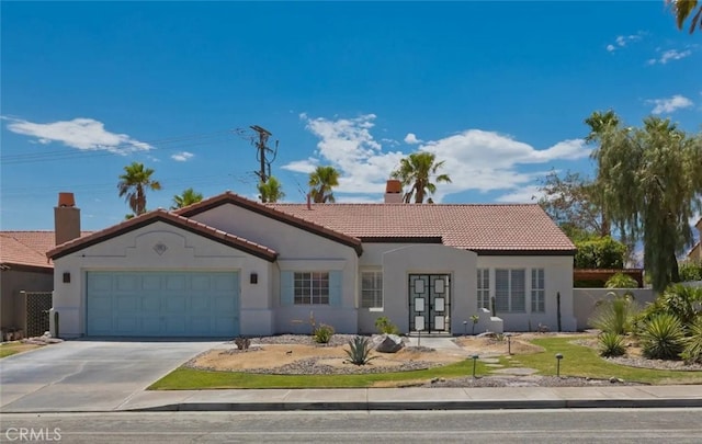 mediterranean / spanish house with french doors and a garage