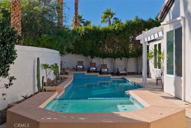 view of pool with a pool with connected hot tub, a patio area, a pergola, and a fenced backyard