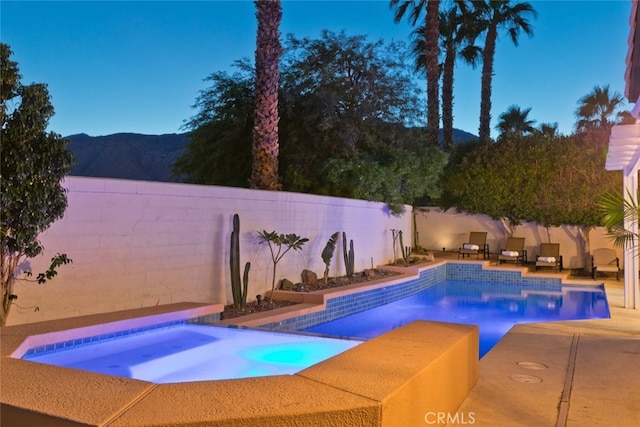 view of pool with a fenced in pool, an in ground hot tub, a fenced backyard, and a patio area