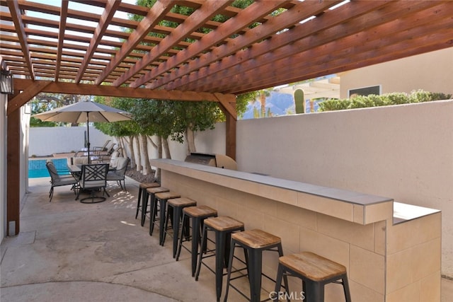 view of patio featuring outdoor dining space, a pergola, and fence