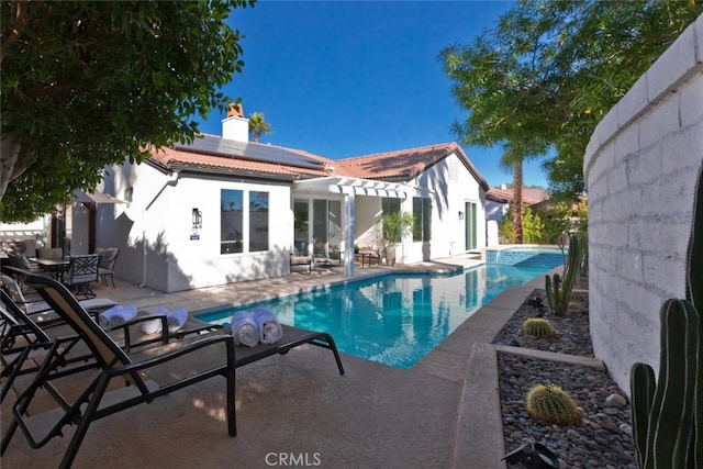 outdoor pool with a patio area