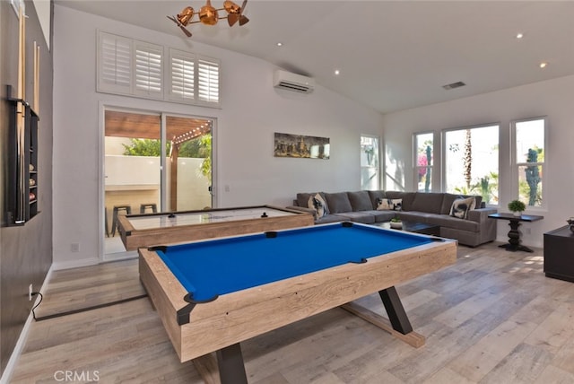 playroom with billiards, high vaulted ceiling, a wall mounted AC, and light wood finished floors