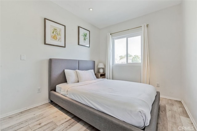 bedroom featuring light wood-style flooring and baseboards