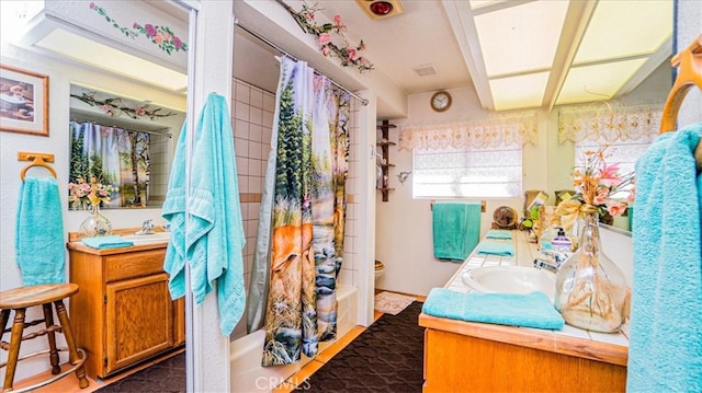 full bathroom featuring vanity, toilet, and shower / tub combo