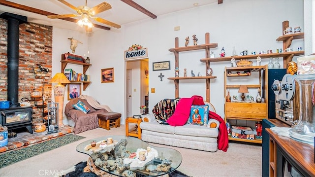 interior space with beamed ceiling, ceiling fan, and a wood stove