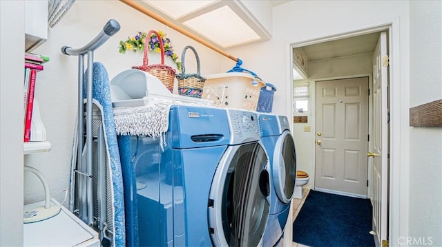 laundry room featuring washing machine and clothes dryer