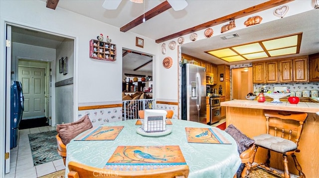 tiled dining space with ceiling fan