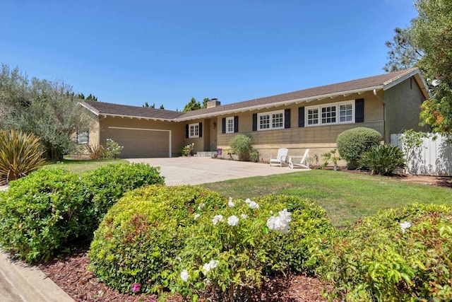 ranch-style house featuring a front yard and a garage