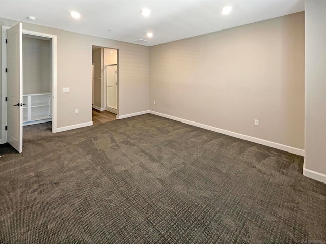 unfurnished bedroom featuring dark colored carpet