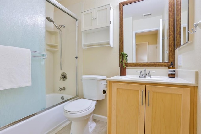 full bathroom with vanity, shower / bath combination with glass door, tile patterned flooring, and toilet