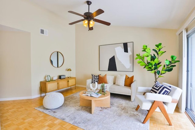 living room featuring lofted ceiling, parquet floors, and ceiling fan