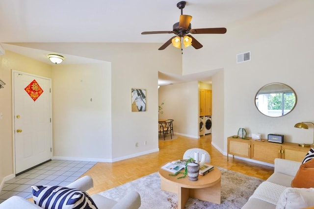 living room with ceiling fan, light parquet flooring, washer / dryer, and lofted ceiling