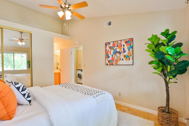 bedroom with ensuite bath, washer / clothes dryer, light parquet flooring, a closet, and ceiling fan