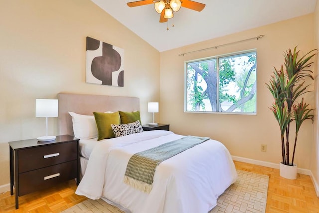 bedroom featuring light parquet flooring, vaulted ceiling, and ceiling fan