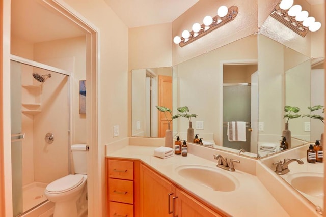 bathroom featuring an enclosed shower, vanity, and toilet