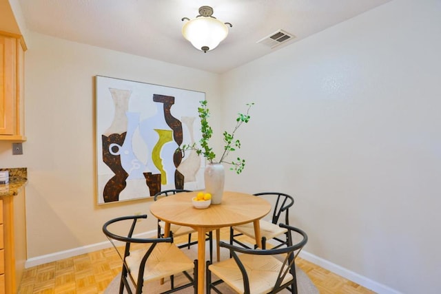 dining room featuring light parquet floors