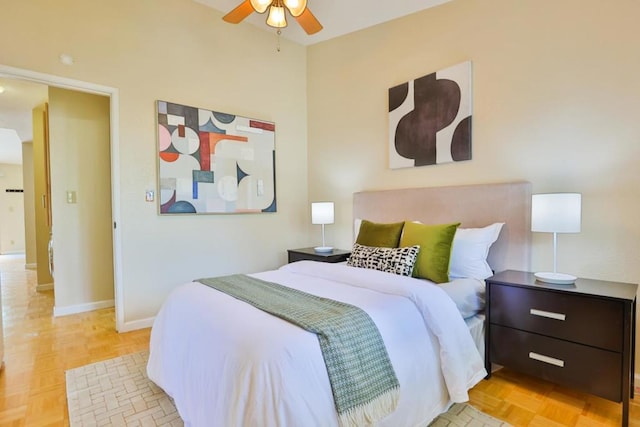 bedroom with ceiling fan and light parquet flooring