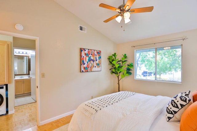 bedroom with vaulted ceiling, light parquet floors, sink, ceiling fan, and connected bathroom