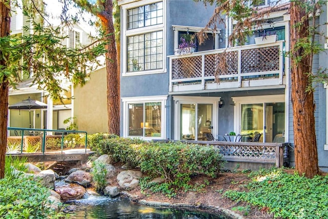 rear view of property featuring a balcony